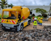 group of construction figures next to concrete truck