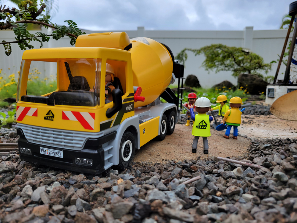 group of construction figures next to concrete truck