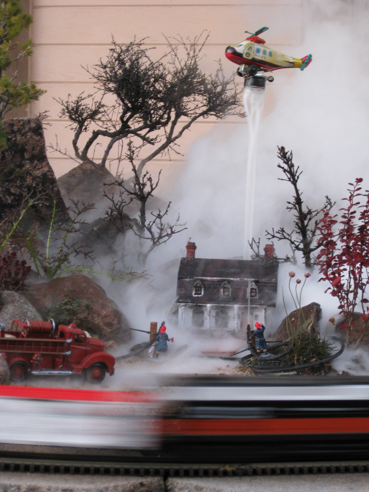 model of smoking house with helicopter above