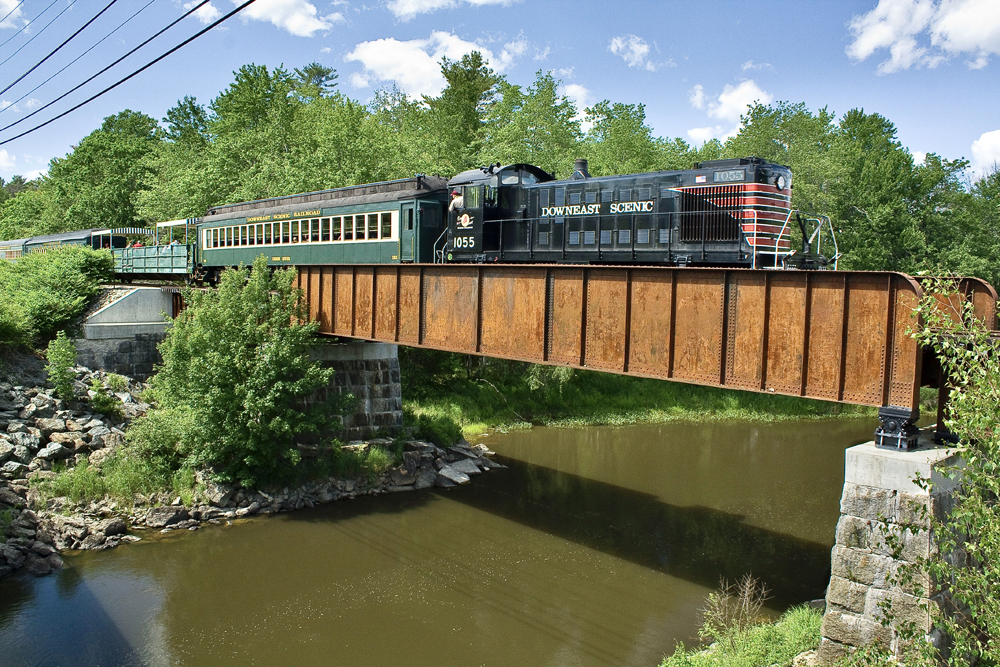 passenger train crosses bridge