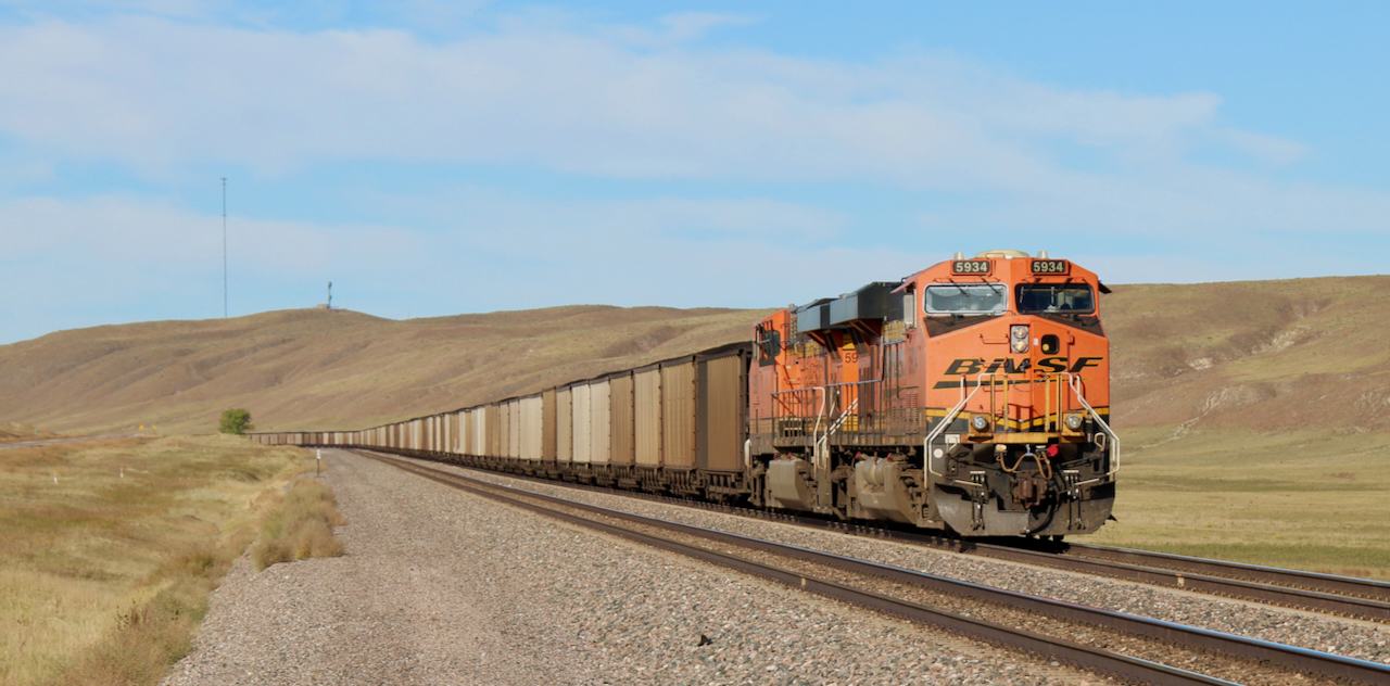 Diesel-powered coal train in rolling hills. FRA railroad brakes safety.