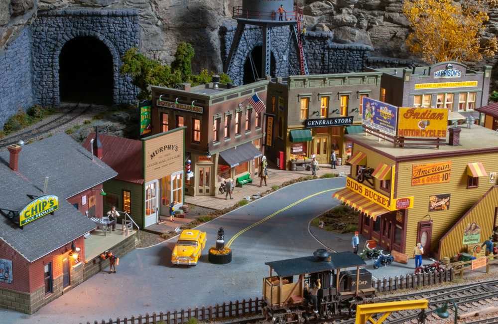 A scene of a downtown street surrounded by picturesque storefronts