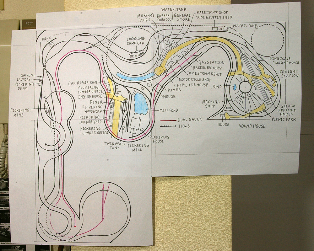 A track plan drawn on paper hanging on a wall