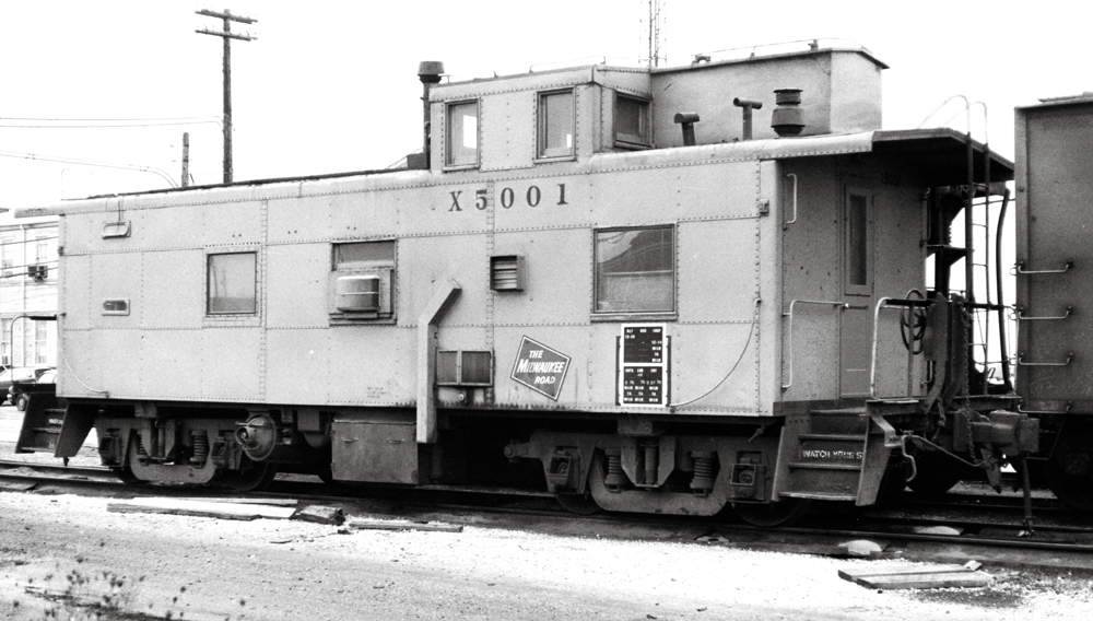 Black-and-white photo of steel cupola caboose.