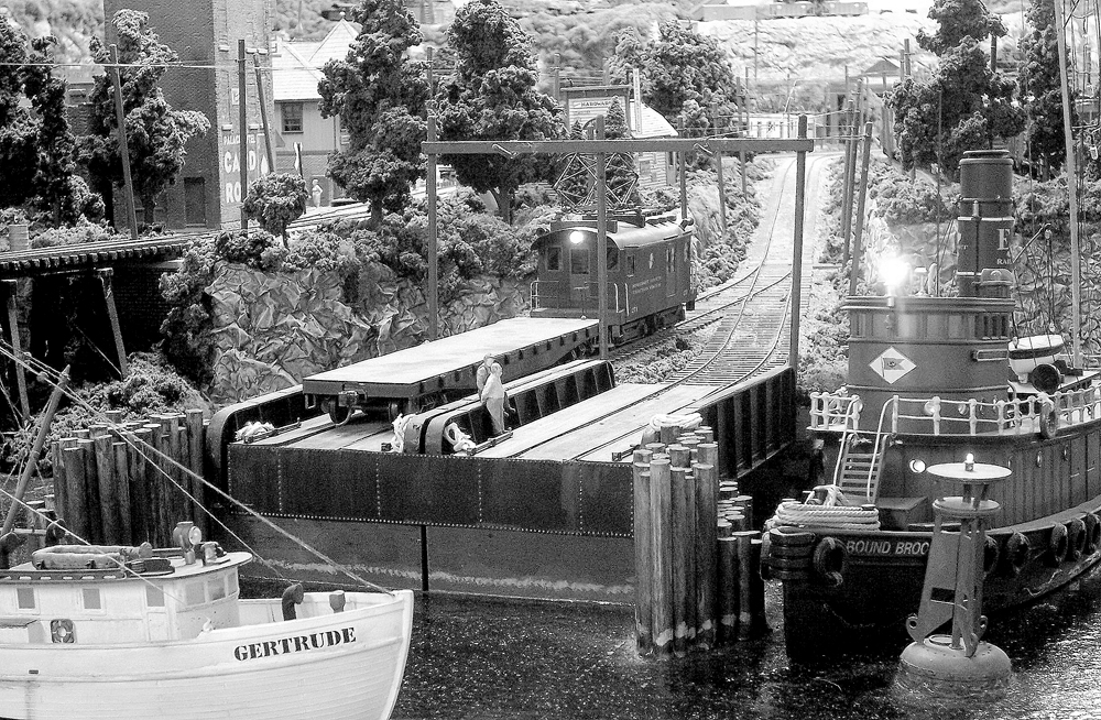 black and white photo of scene near water on model train layout