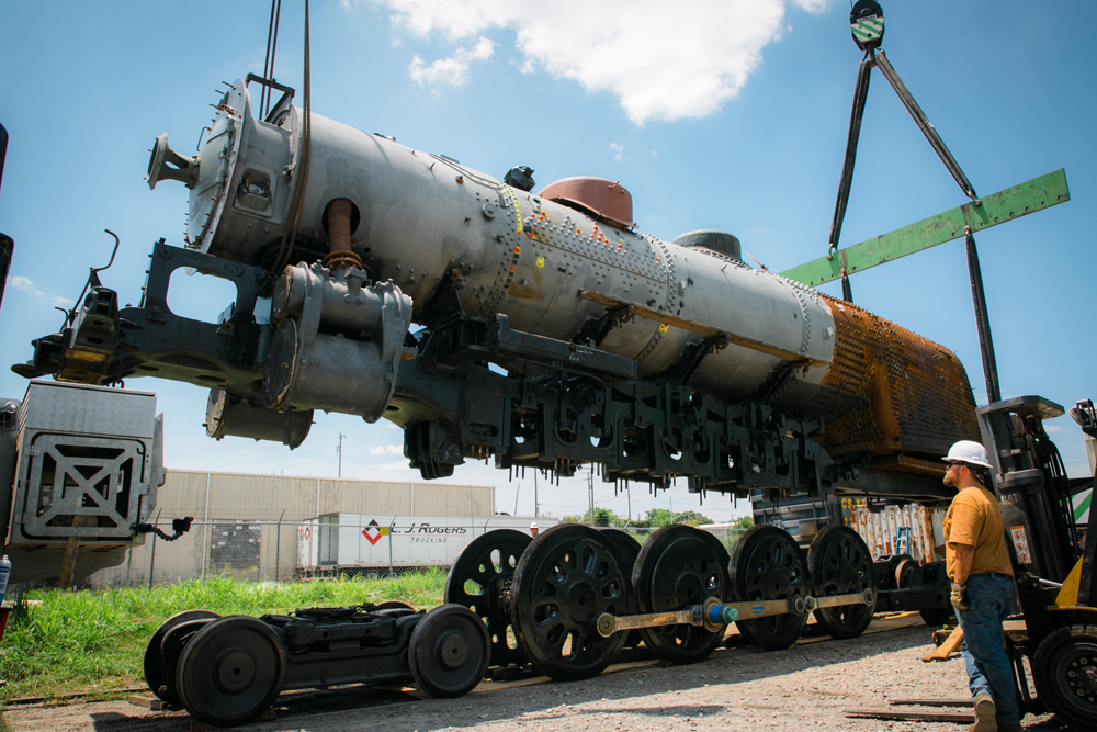 Locomotive boiler and firebox are lowered onto wheels and trucks