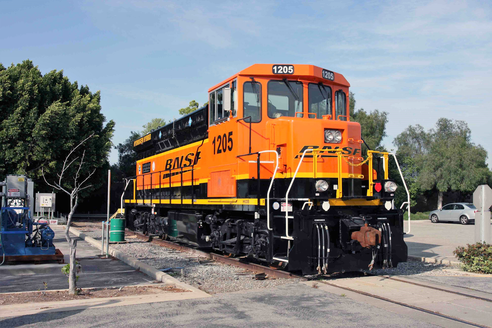 Orange and green switcher parked at yard