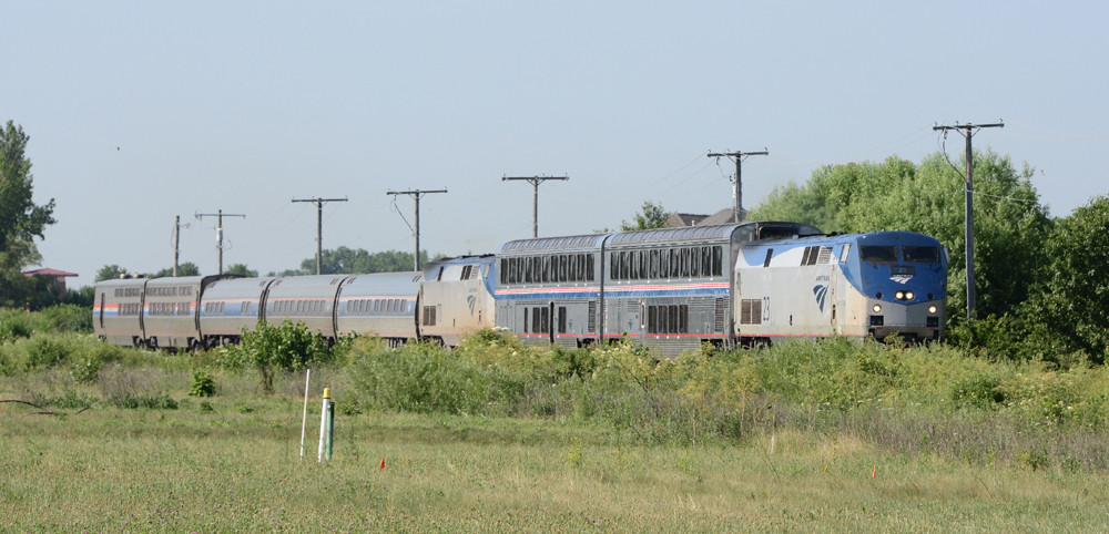 Passenger train with mismatched equipment and one locomotive in middle of train