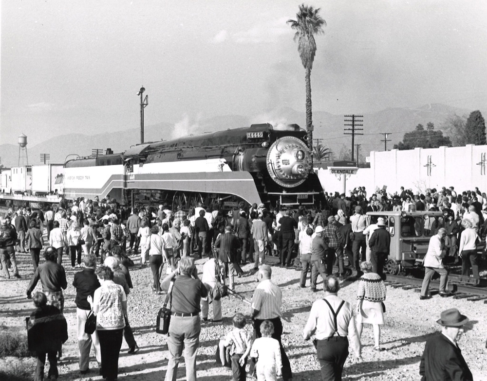 Steam locomotive surrounded by huge crowd