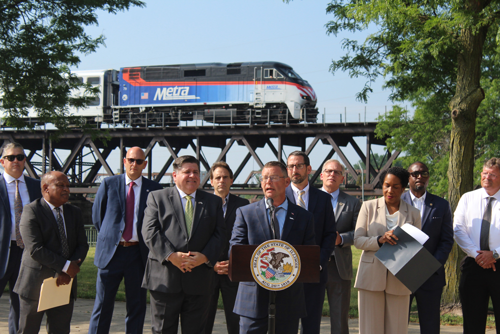 People speaking with train in background