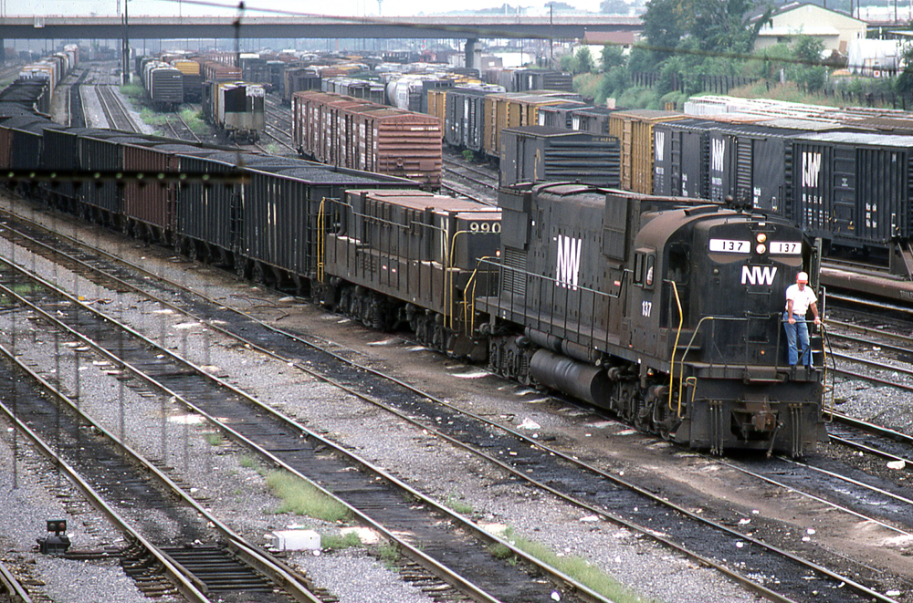 Black locomotive with slug unit pulling hopper cars