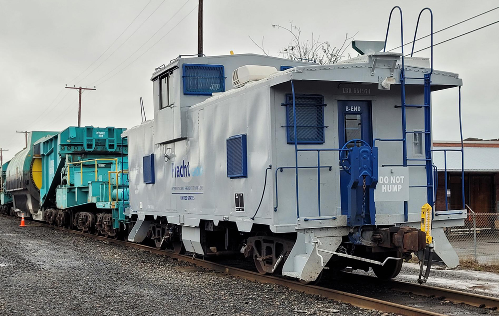 Gray extended cupola caboose with Schnabel car