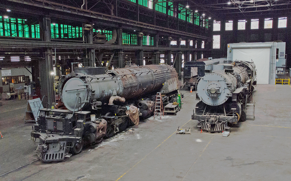 Two steam locomotives in shop building