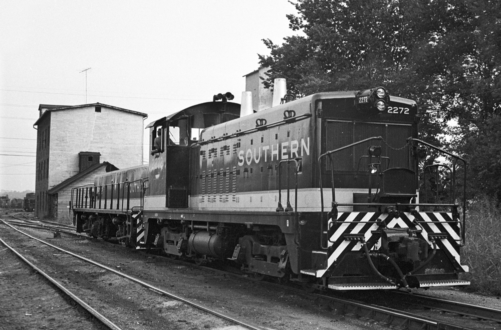 Black-and-white photo of end-cab switcher and slug