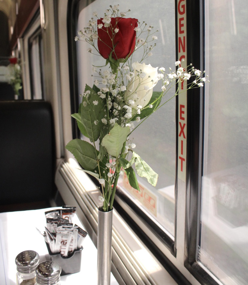 Flower in silver vase on dining-car table