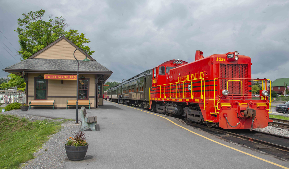 Passenger train with bright red end-cab switch engine