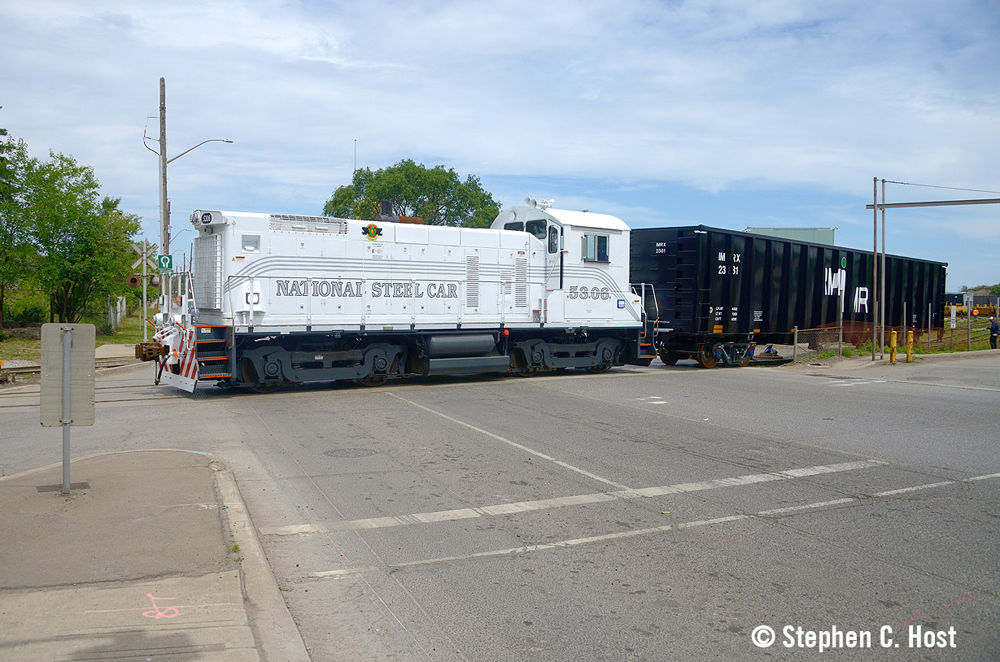 White end-cab switcher moves cars