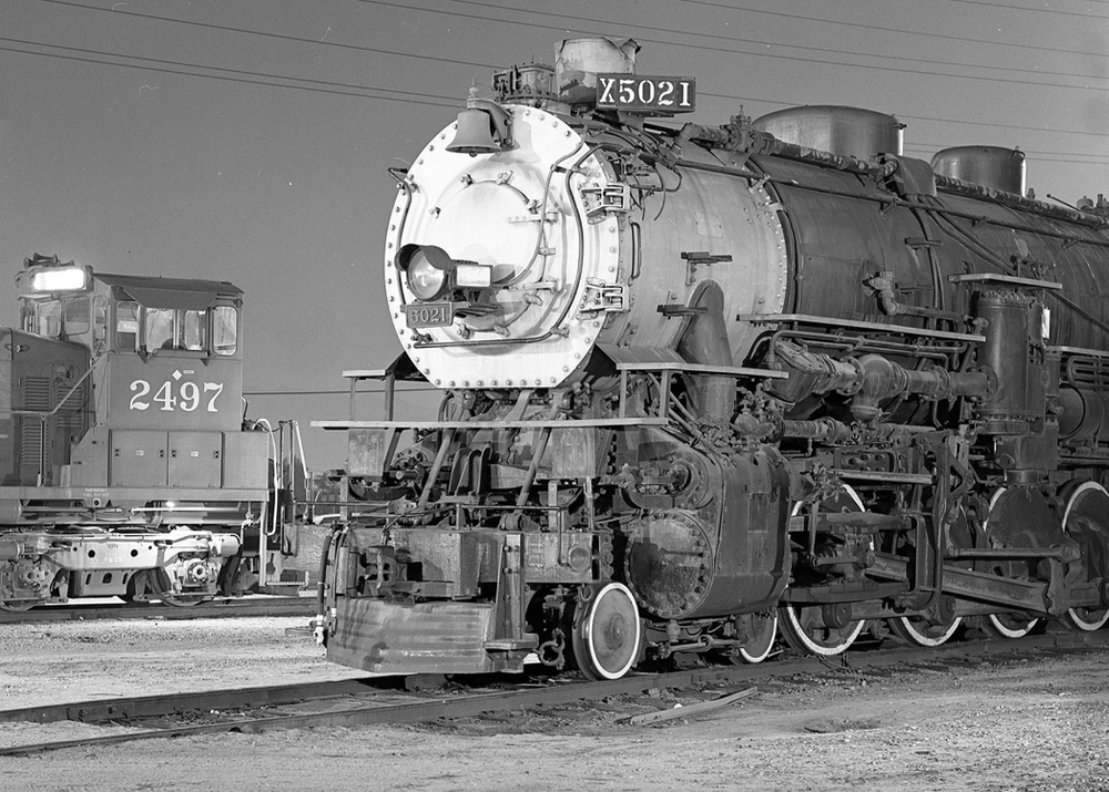 Steam engine next to SW1500 switcher