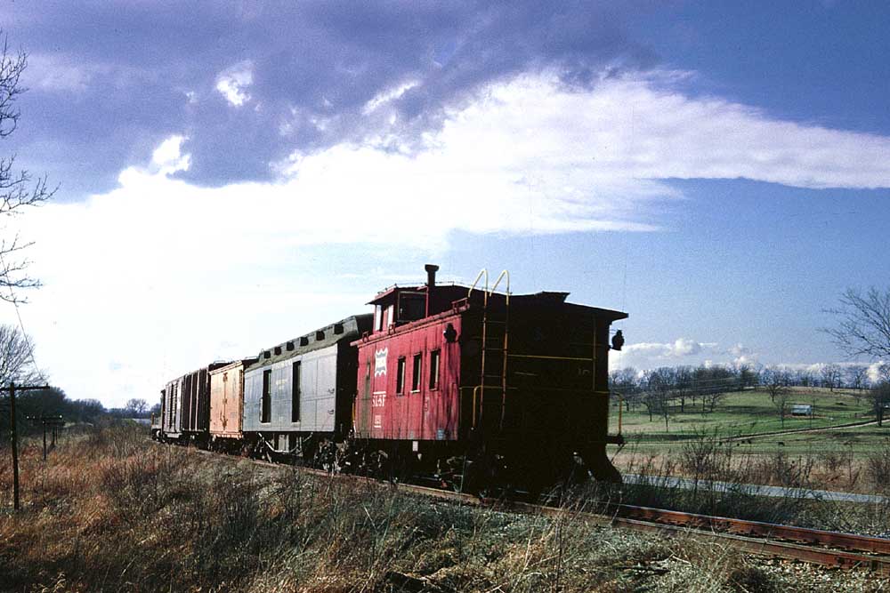 Red caboose on Frisco mixed train