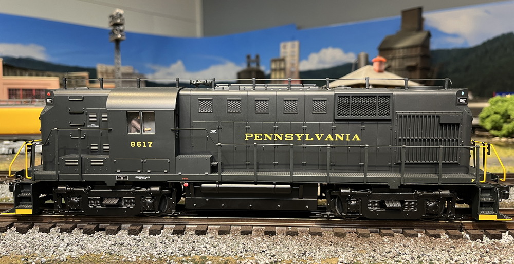 side view of dark green diesel locomotive