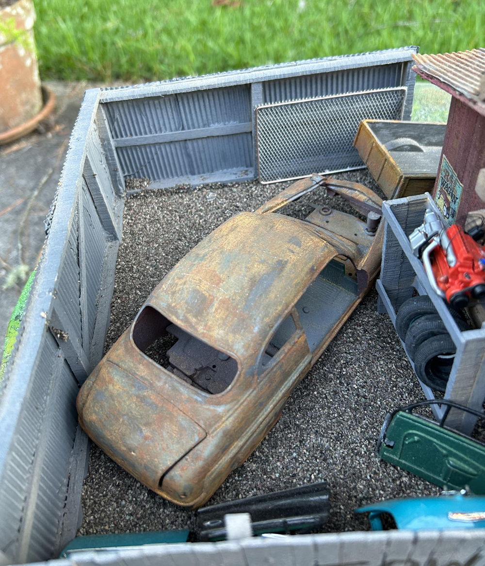 model of a junked truck with debris around it