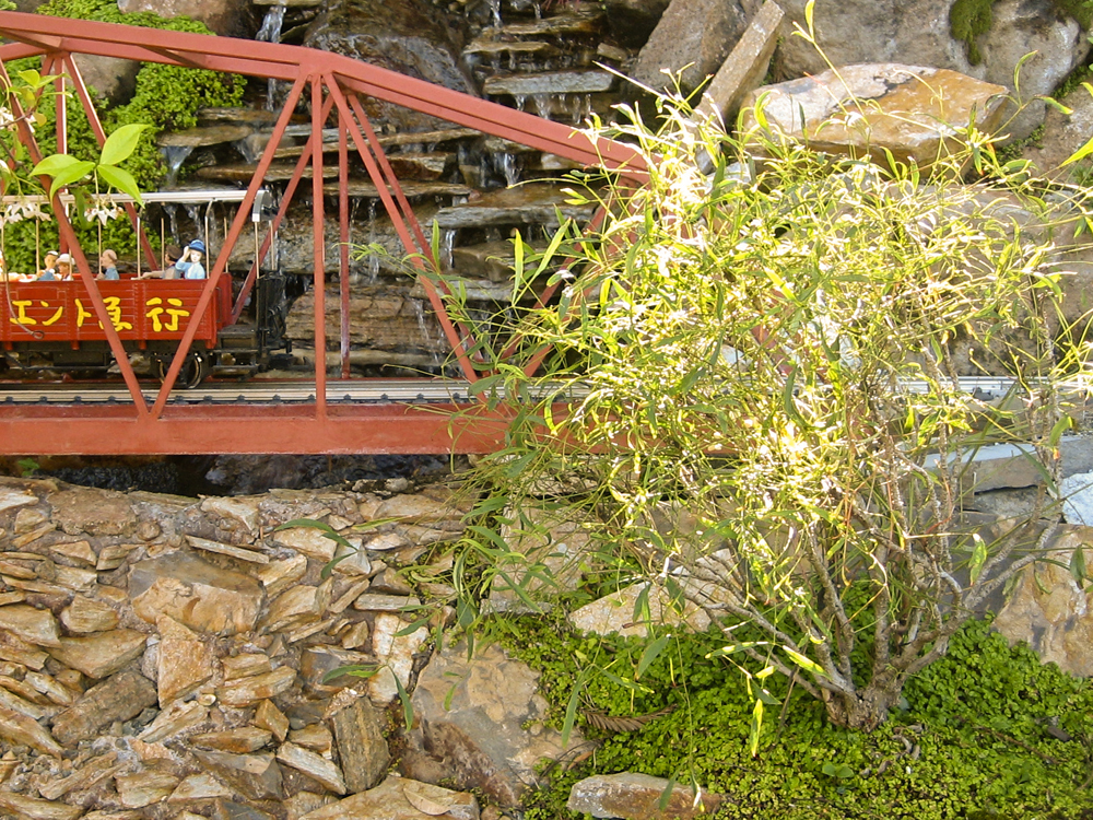 red bridge with red trolley and a tree on the right side