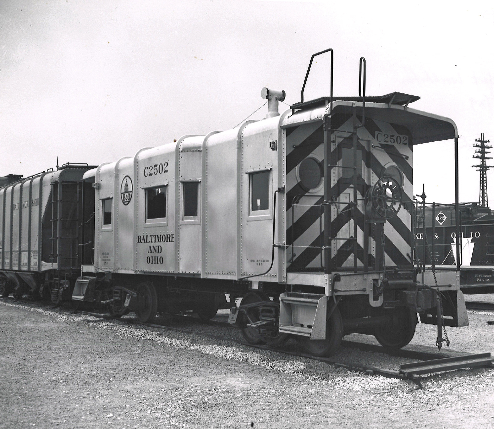 Caboose with rounded corners at the point where the wall meets the roof.