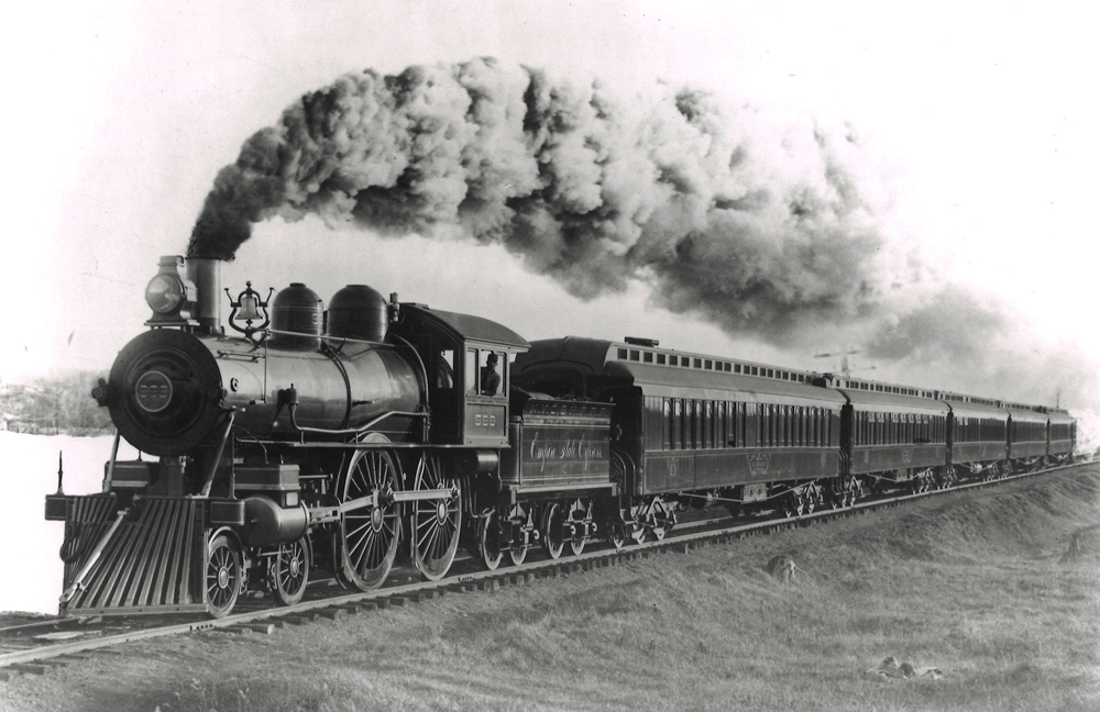 Black and white photo of a steam locomotive and passenger train
