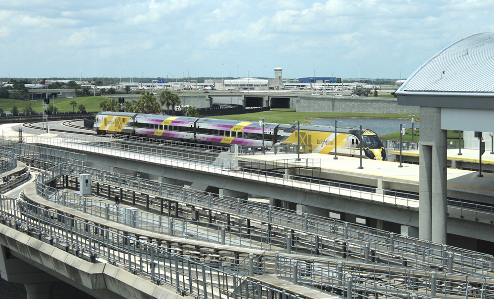 Yellow and white passenger train at station