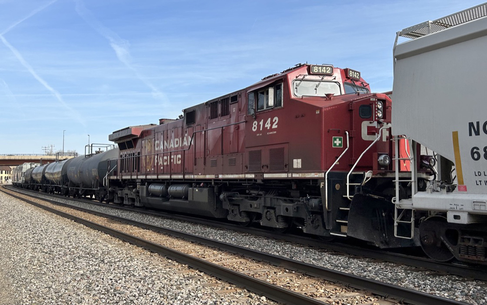 Red diesel locomotive in the middle of a train