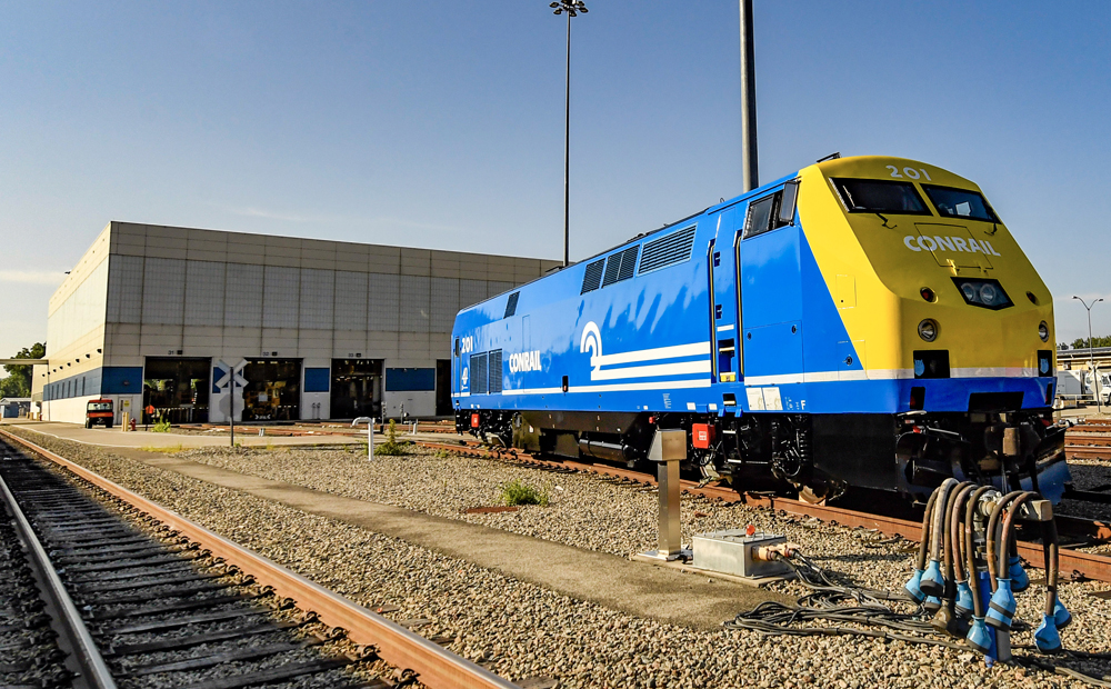 Blue and yellow diesel outside shop building