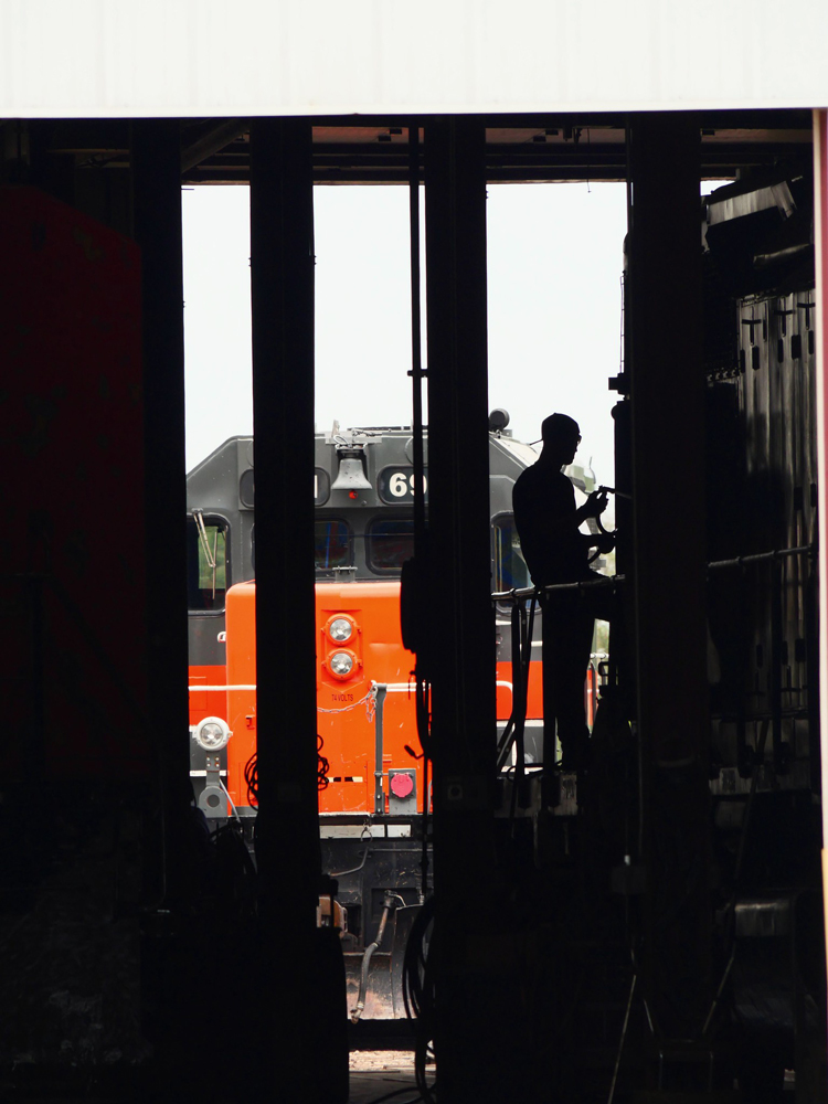Silhouette of worker in shop building
