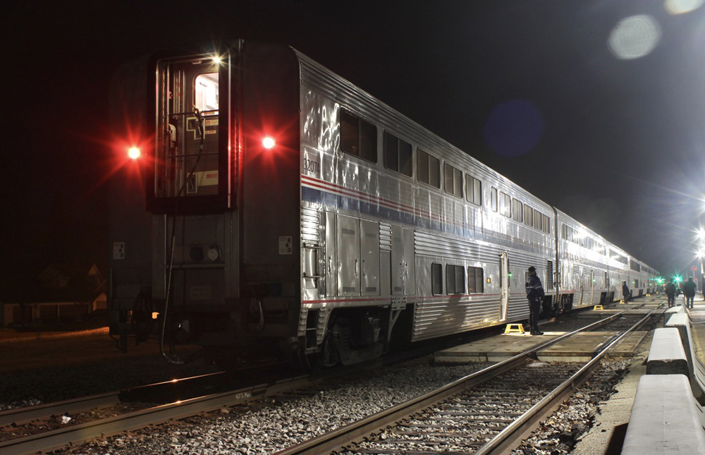 Bilevel passenger cars at station at night