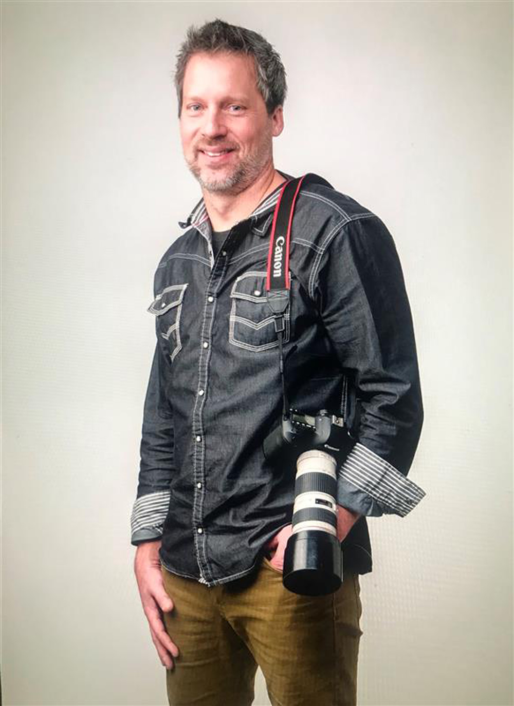 man standing with camera