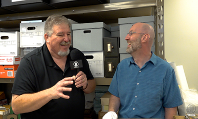 Trains LIVE — National Railroad Museum library expands. Two men talking during a TV interview.