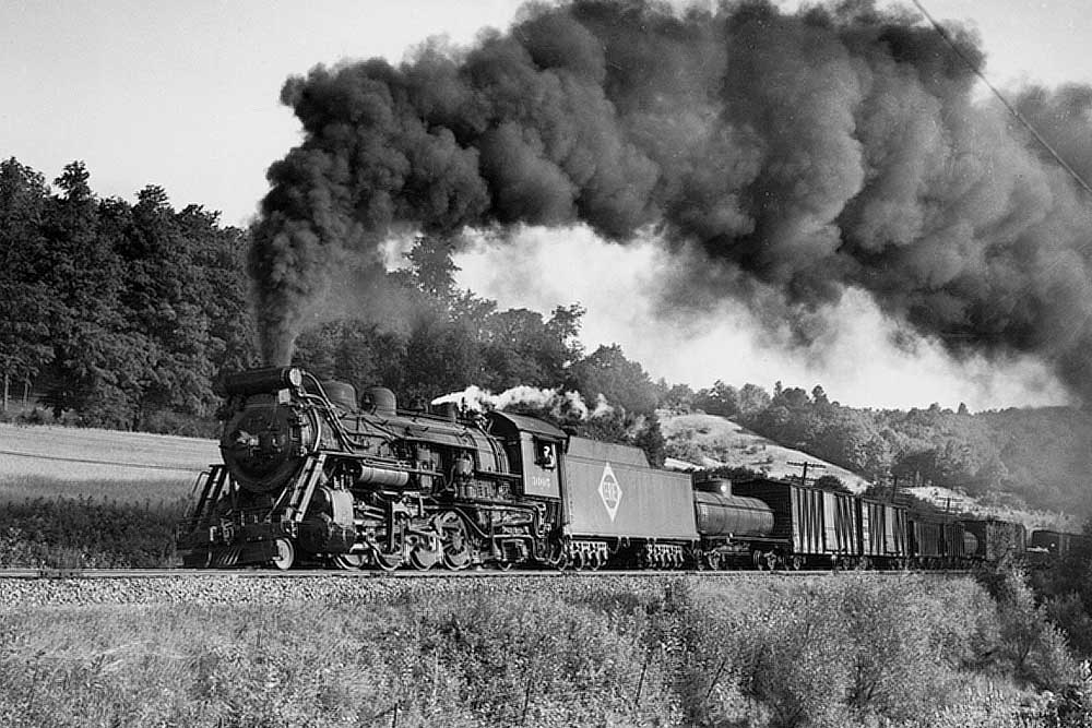 Steam Erie Railroad locomotives with freight train in country