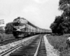 Two streamlined diesel Erie Railroad locomotives with passenger train on curve