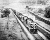 Two diesel Erie Railroad locomotives with freight train in valley