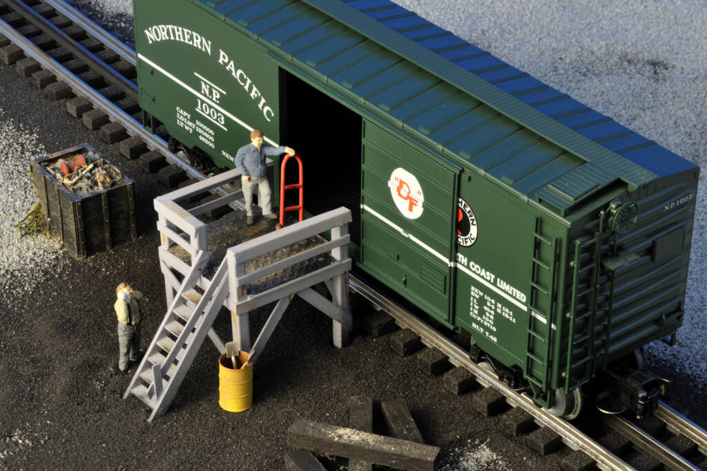 model boxcar with unloading platform on layout