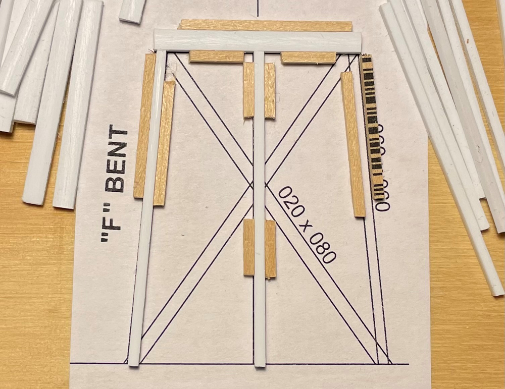 Photo of plans attached to plywood with pieces of stripwood and styrene