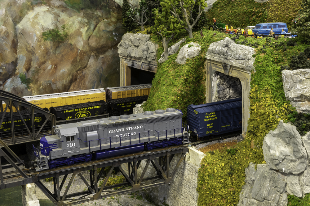 The Grand Strand Western Railroad layout: Two model trains passing on bridges through tunnels