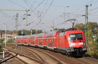 Red, electric, bi-level passenger train on a curve