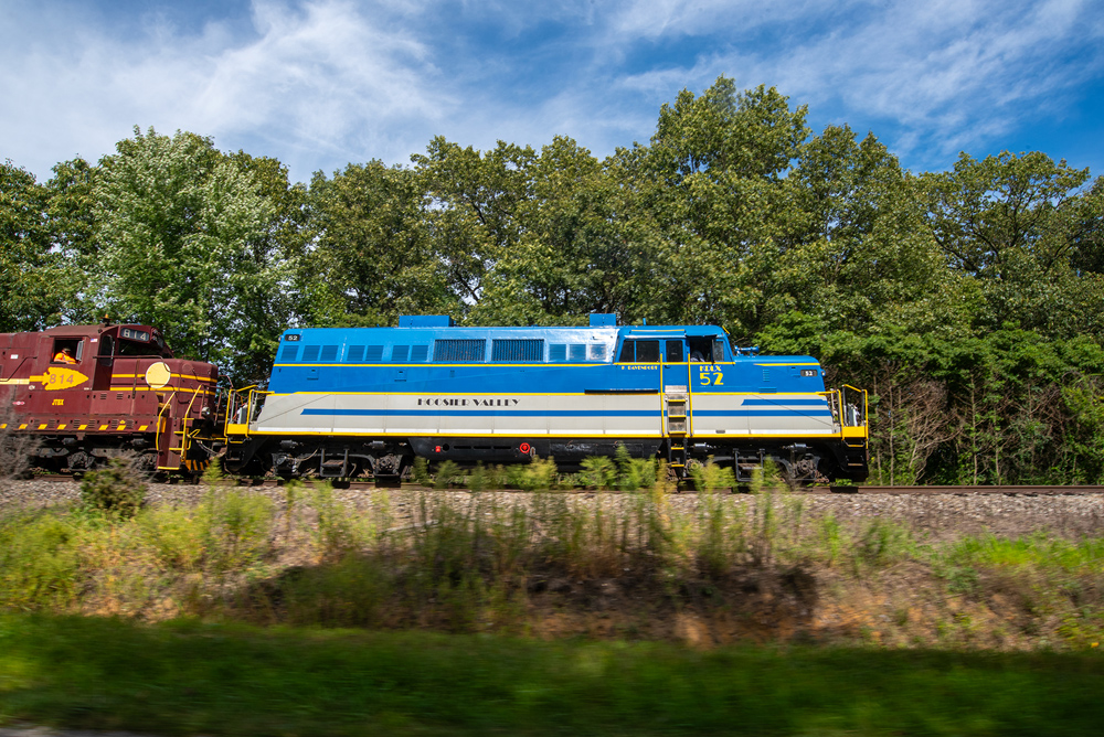 blue, yellow, gray engine with trees