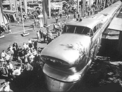Aerotrain on outdoor exhibit with crowd of people.