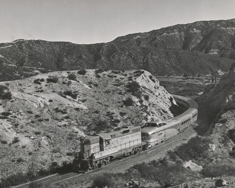 Diesel locomotive pulling the Aerotrain through a mountain pass.