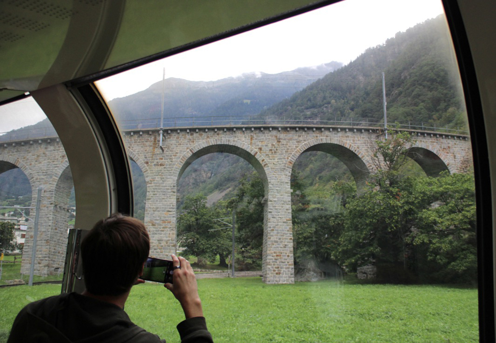 Stone viaduct seen through train windows