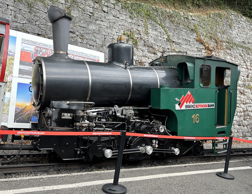 Black steam locomotive with green cab