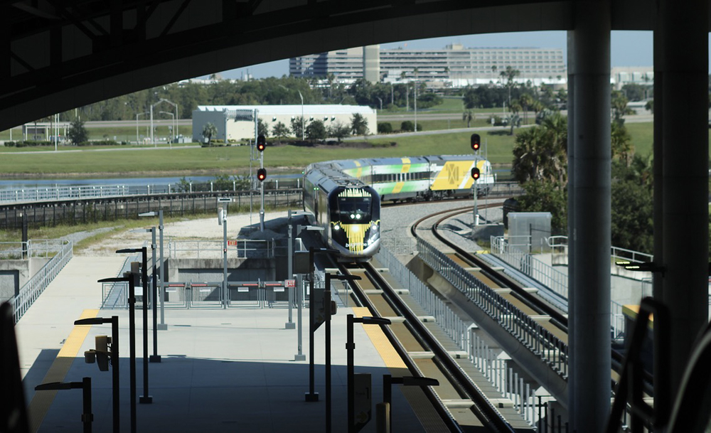 Train arrives at station as seen from statron building