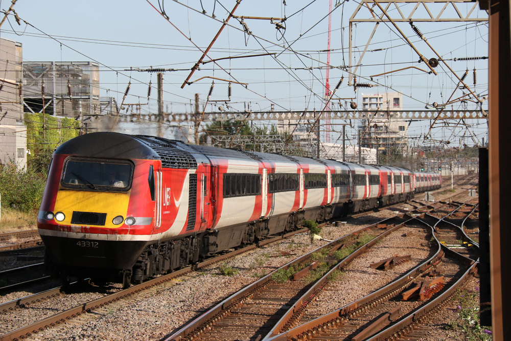 Red and white diesel High Speed Train under catenary in England