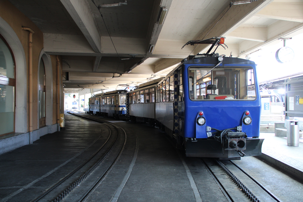 Two two-car trains at station.